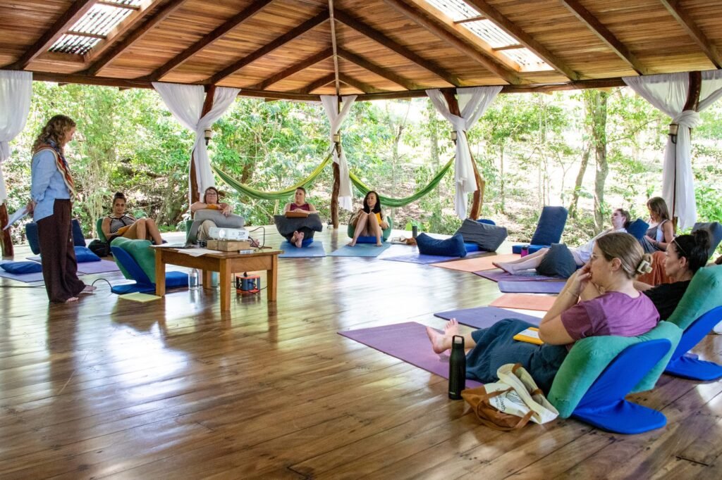 Open-air workshop pavilion with mats and hammocks at the Costa Rica retreat