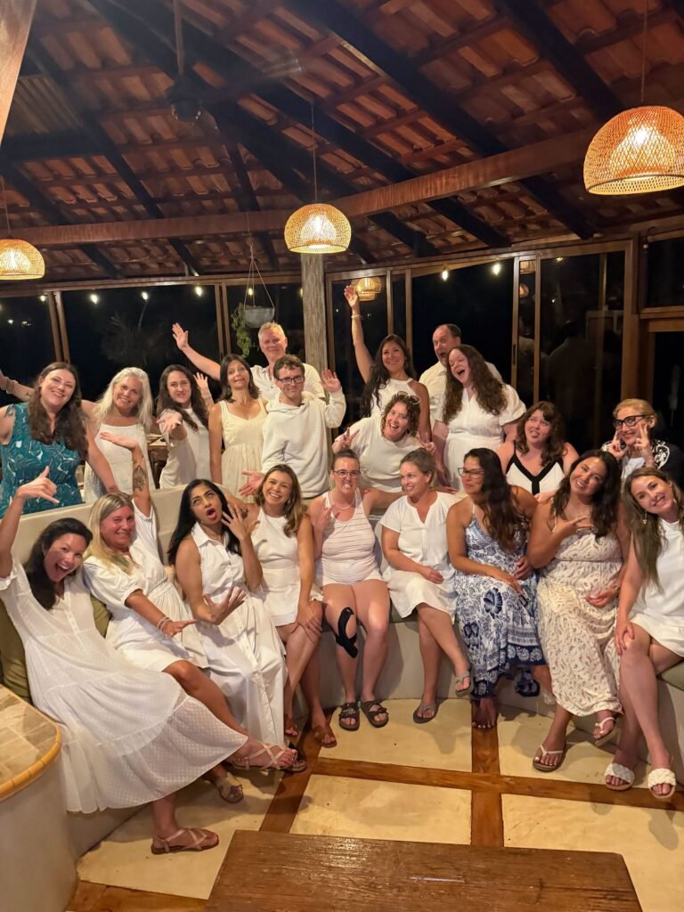 Retreat group in white celebrating together on the last night