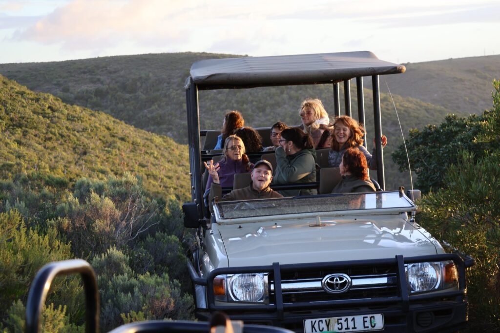 Retreat guests heading out on a safari game drive in South Africa